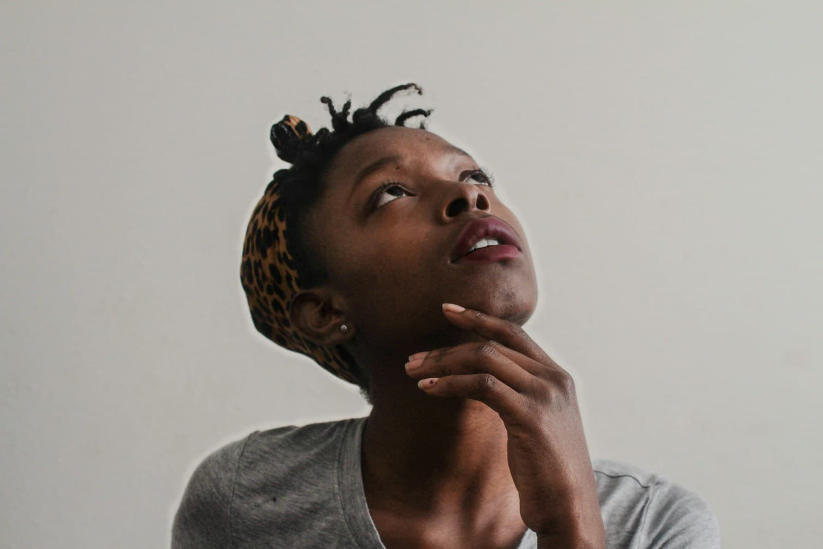 Woman looking thoughtfully upward, considering a decision